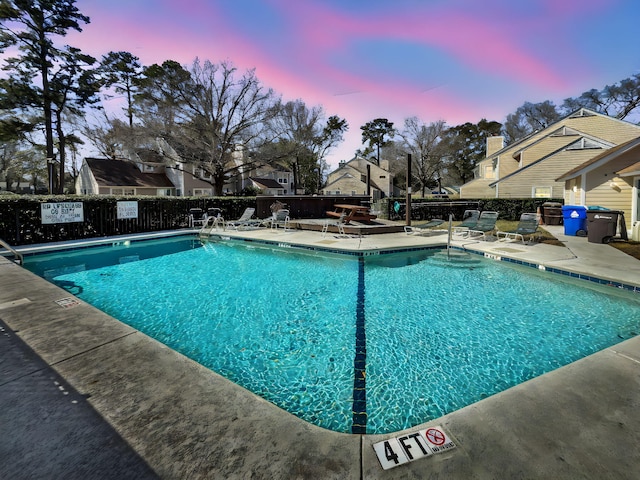 community pool featuring a patio and fence