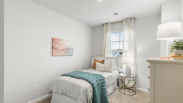 bedroom featuring light carpet