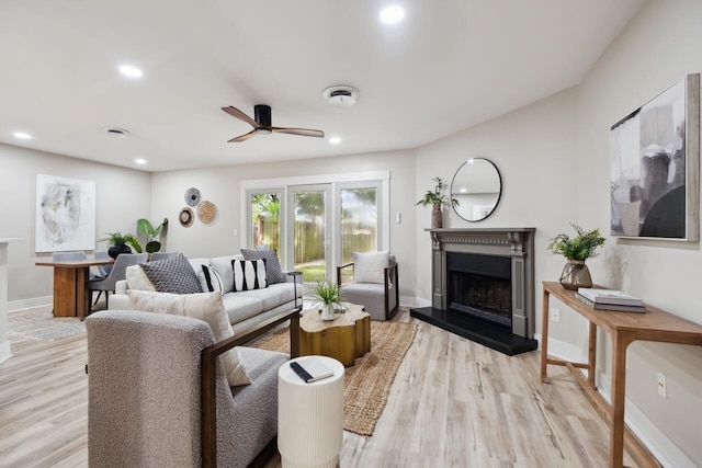 1161 Monaco Dr, Mount Pleasant, SC 29464 - living area featuring a fireplace with raised hearth, a ceiling fan, recessed lighting, and light wood-type flooring