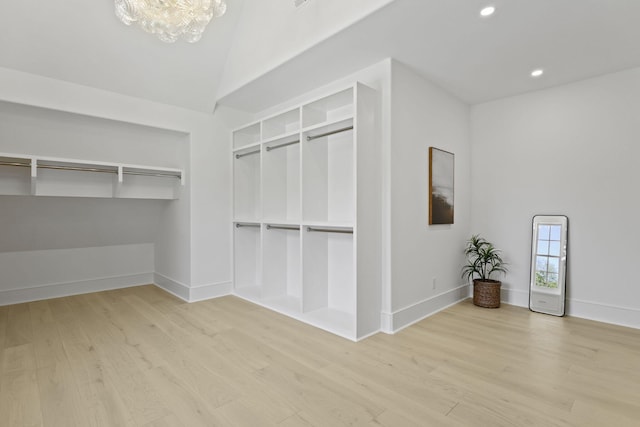 755 Adluh St, Mount Pleasant, SC 29464 - walk in closet featuring an inviting chandelier, a towering ceiling, and wood finished floors
