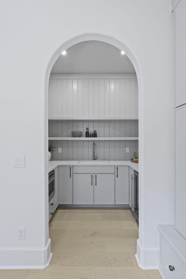 755 Adluh St, Mount Pleasant, SC 29464 - bar featuring arched walkways, a sink, light wood finished floors, and wine cooler