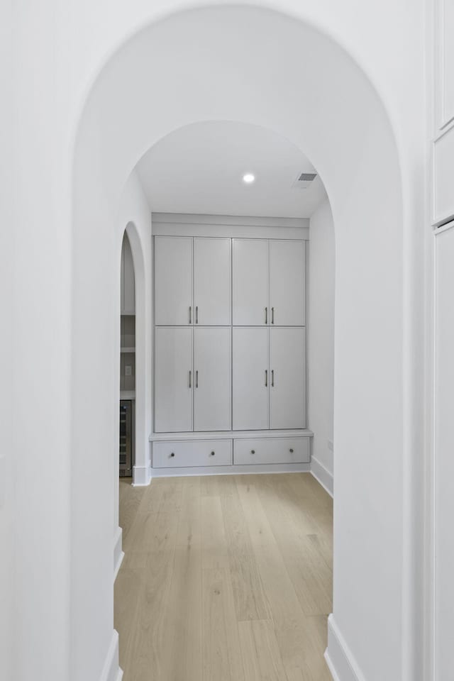 755 Adluh St, Mount Pleasant, SC 29464 - hallway featuring arched walkways, baseboards, and light wood-type flooring