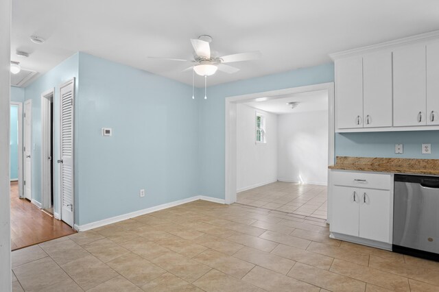 kitchen featuring light tile patterned flooring, ceiling fan, white cabinetry, baseboards, and stainless steel dishwasher