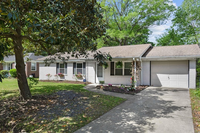 ranch-style house with a shingled roof, a front lawn, brick siding, a garage, and concrete driveway