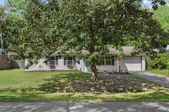 obstructed view of property featuring brick siding, an attached garage, driveway, and a front lawn