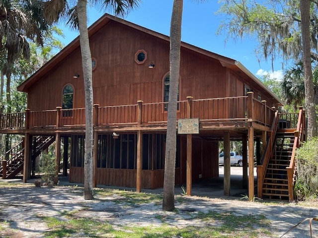 209 Jungle Rd, Edisto Beach, SC 29438 - view of front facade with stairway and a wooden deck