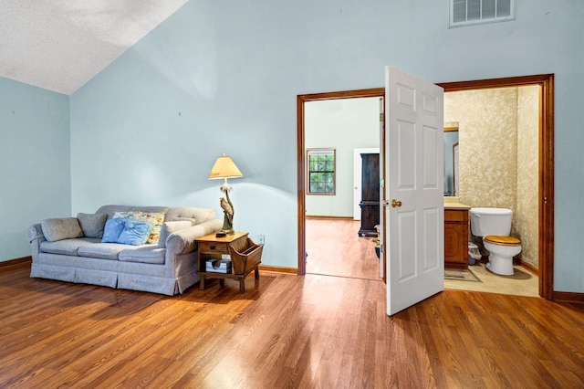 209 Jungle Rd, Edisto Beach, SC 29438 - living area featuring wood finished floors, baseboards, and high vaulted ceiling