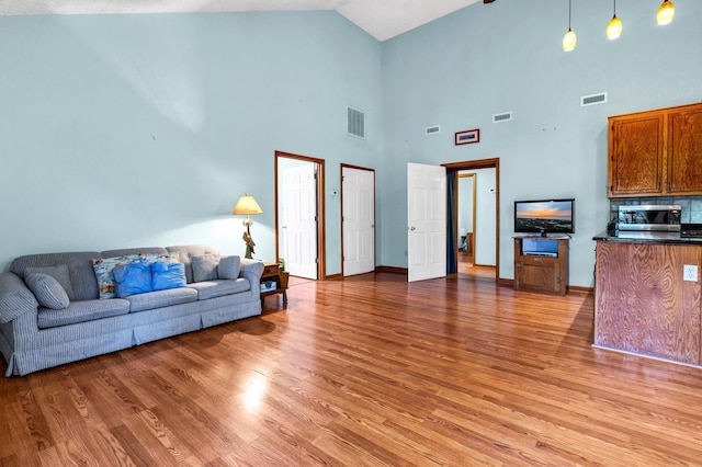 209 Jungle Rd, Edisto Beach, SC 29438 - living area with light wood finished floors, high vaulted ceiling, and baseboards