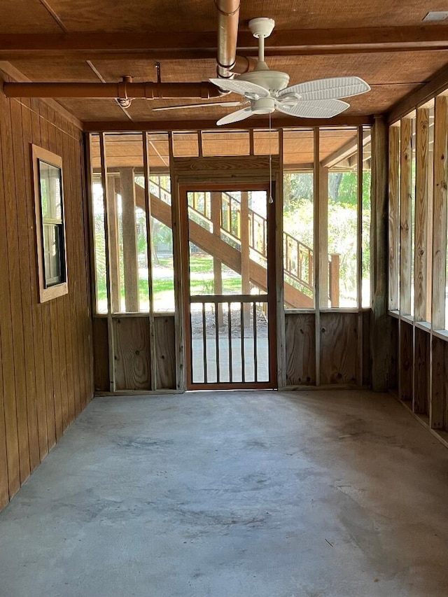 209 Jungle Rd, Edisto Beach, SC 29438 - miscellaneous room featuring unfinished concrete floors, ceiling fan, healthy amount of natural light, and wood walls