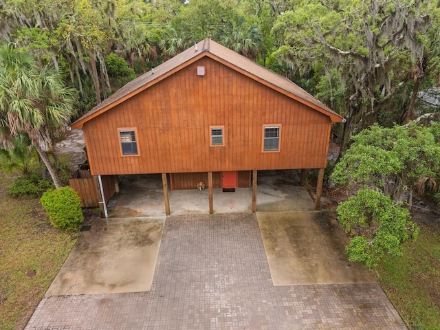 209 Jungle Rd, Edisto Beach, SC 29438 - view of front of home featuring a carport and decorative driveway