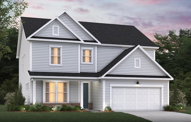 view of front of house with a yard and a garage