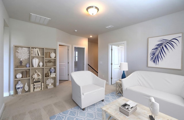 living area featuring visible vents, light carpet, and baseboards