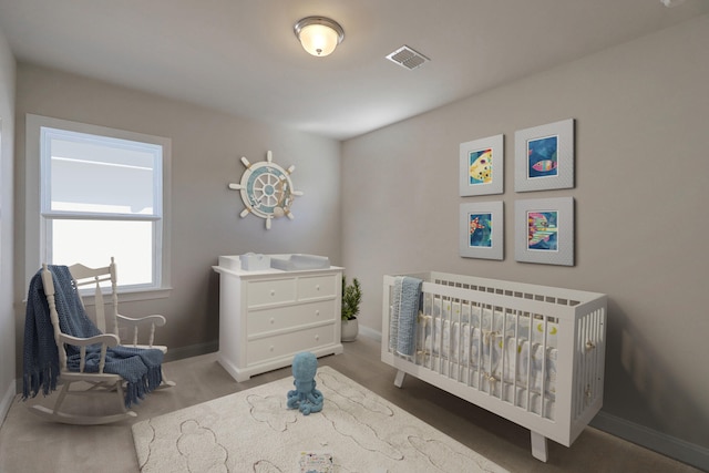 bedroom with a crib, visible vents, and baseboards