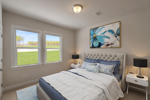 carpeted bedroom with visible vents and baseboards