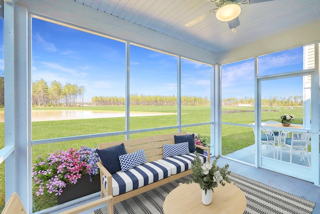 sunroom with a water view and ceiling fan