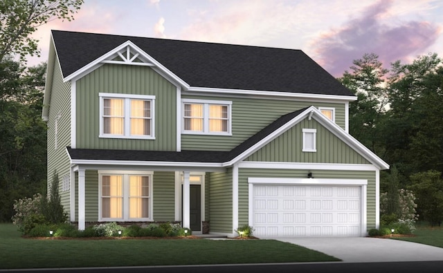 view of front of house featuring board and batten siding, a garage, concrete driveway, and a yard