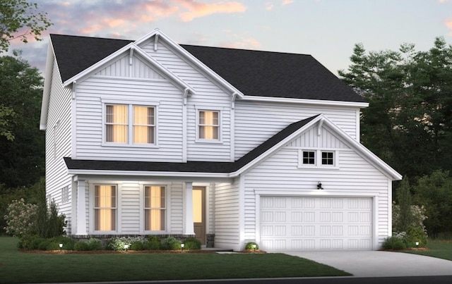 view of front of home featuring concrete driveway, board and batten siding, and a yard