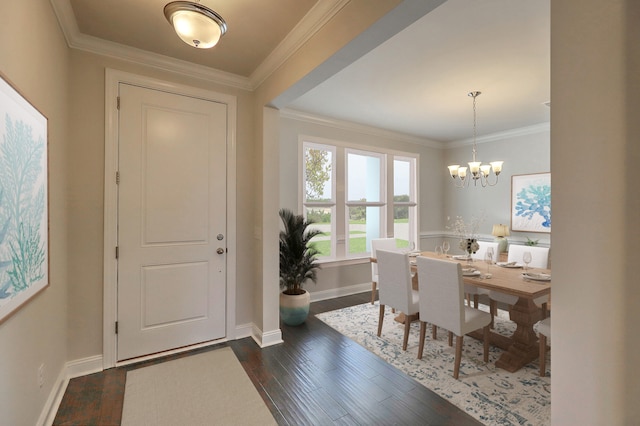 entryway featuring ornamental molding, dark wood-style flooring, a chandelier, and baseboards