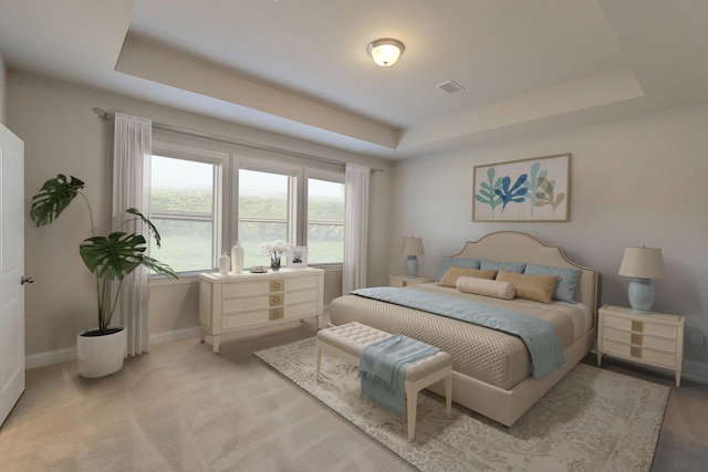 bedroom featuring a tray ceiling, light colored carpet, visible vents, and baseboards