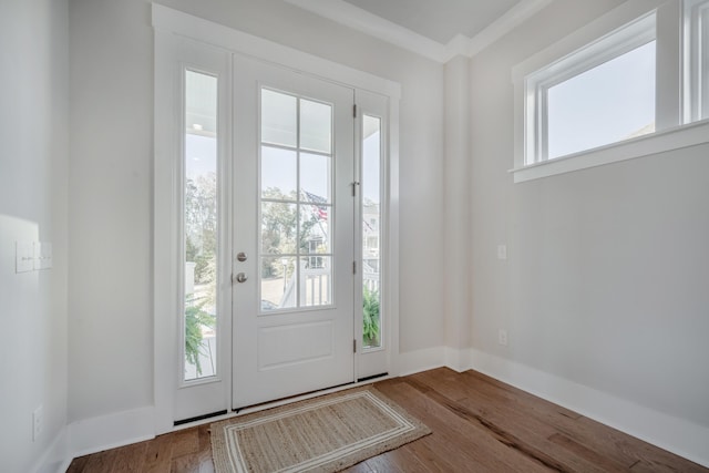 doorway featuring baseboards and wood finished floors