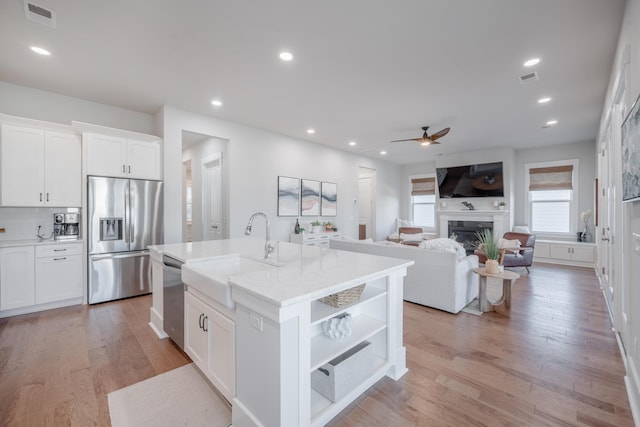 kitchen featuring ceiling fan, visible vents, a sink, appliances with stainless steel finishes, and white cabinetry