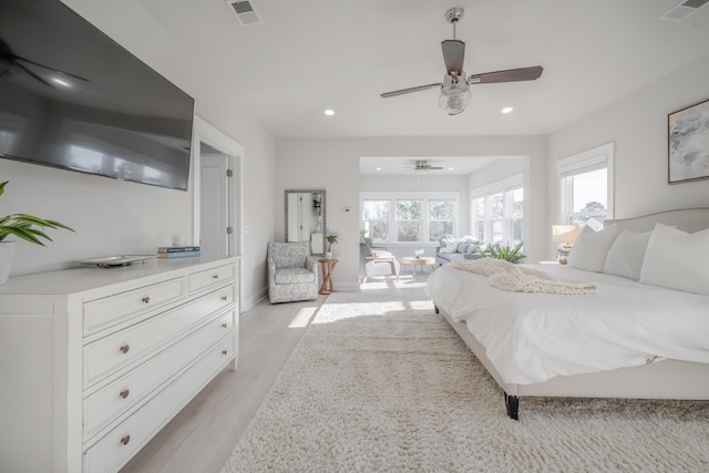 bedroom featuring light wood finished floors, baseboards, visible vents, and recessed lighting