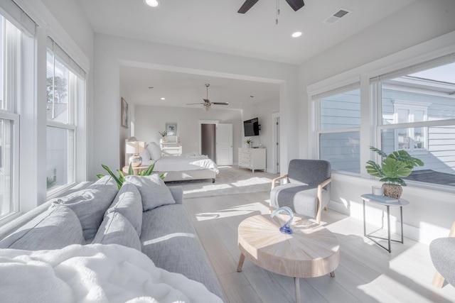 living room featuring ceiling fan, recessed lighting, visible vents, and light wood-type flooring