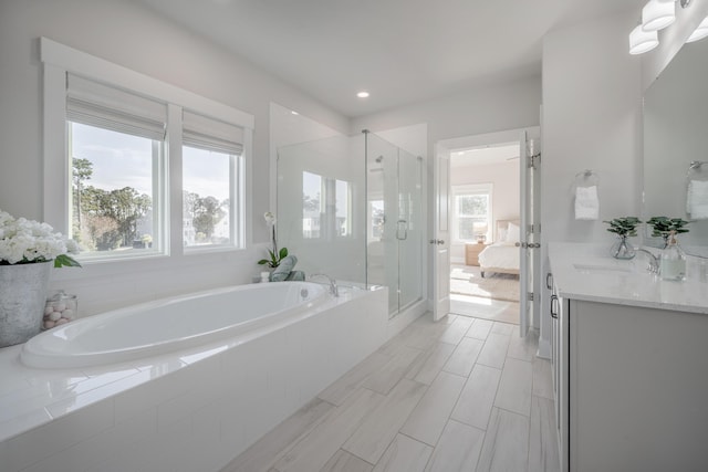 bathroom with recessed lighting, vanity, a garden tub, a stall shower, and ensuite bathroom