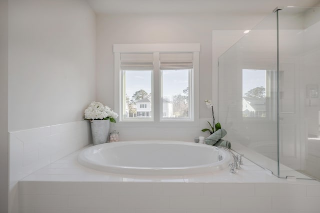 full bath featuring a bath and a stall shower