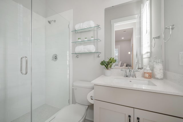 full bath with vanity, toilet, and a stall shower