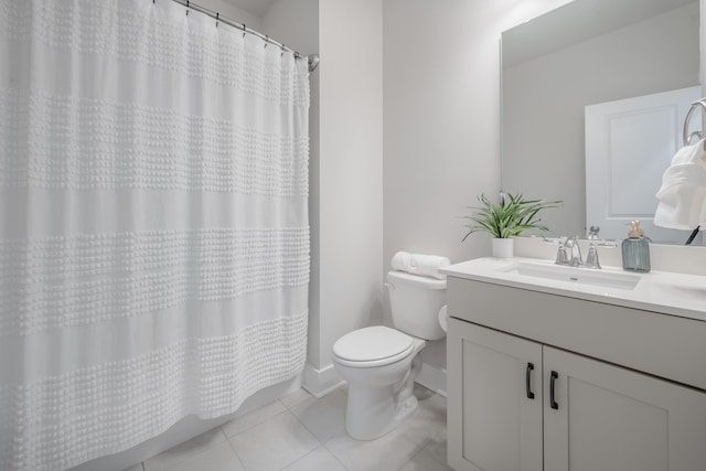 bathroom featuring toilet, a shower with curtain, vanity, and tile patterned floors