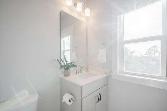 bathroom featuring toilet and vanity