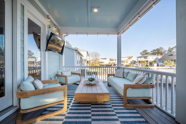 deck featuring an outdoor hangout area and a residential view