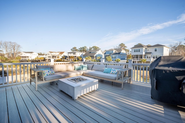 deck with an outdoor living space with a fire pit and a residential view