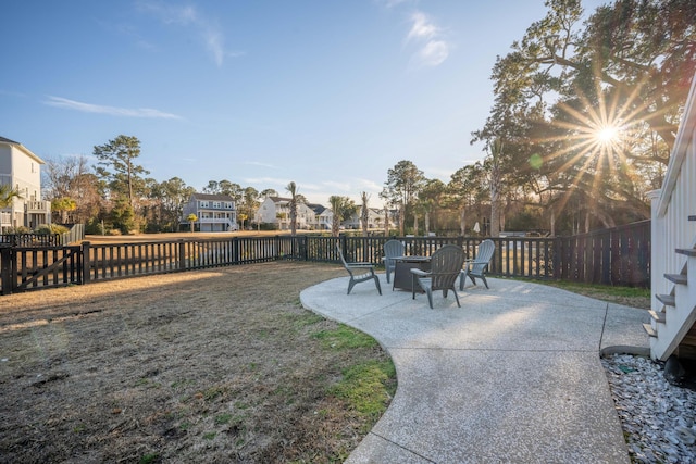 view of yard with a patio area, a fenced backyard, and a residential view