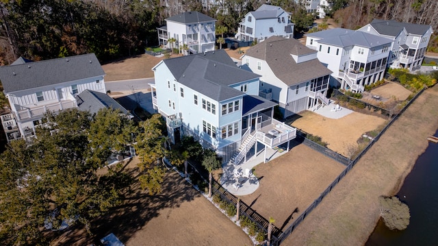 drone / aerial view with a residential view and a water view