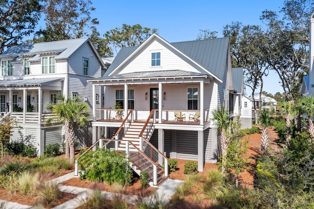 view of front of house featuring a porch, metal roof, stairs, and a standing seam roof