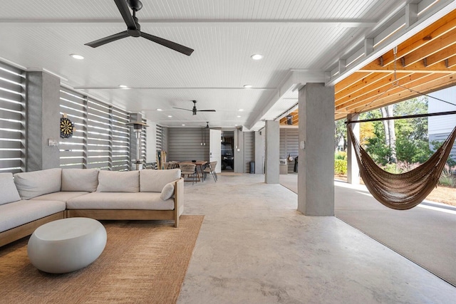 living area featuring recessed lighting, concrete floors, and ceiling fan