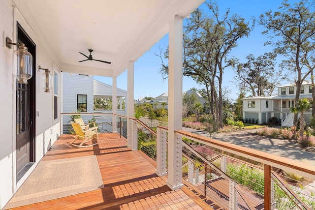 balcony featuring a porch, a residential view, and ceiling fan