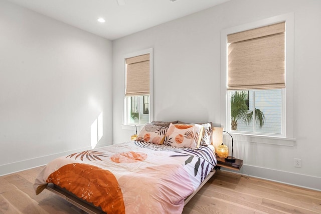 bedroom with recessed lighting, baseboards, and wood finished floors