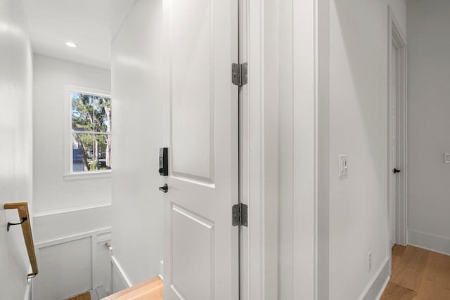 hallway featuring recessed lighting, light wood-type flooring, and baseboards