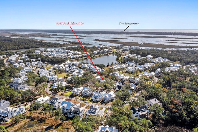 drone / aerial view featuring a residential view and a water view