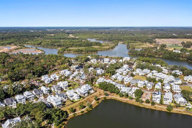 birds eye view of property with a residential view, a view of trees, and a water view