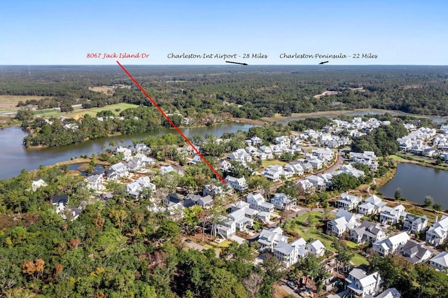 bird's eye view featuring a forest view, a water view, and a residential view