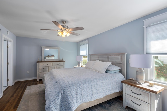 bedroom featuring dark wood-style floors, baseboards, and a ceiling fan