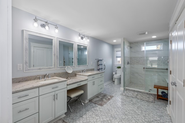 bathroom with recessed lighting, toilet, a stall shower, vanity, and baseboards