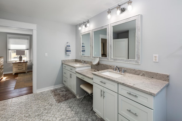 bathroom with vanity and baseboards