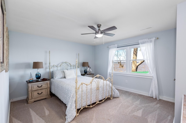 carpeted bedroom with baseboards, visible vents, and ceiling fan