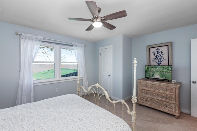 carpeted bedroom featuring ceiling fan and baseboards