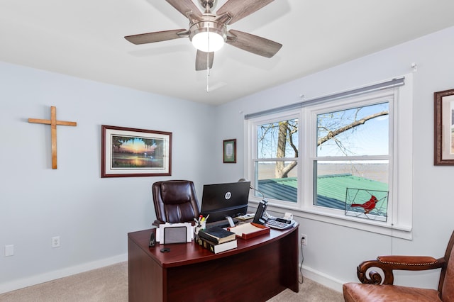 office space with ceiling fan, baseboards, and light colored carpet